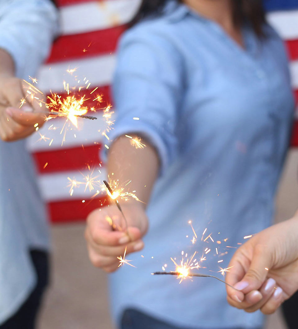 People Holding Lit Sparklers